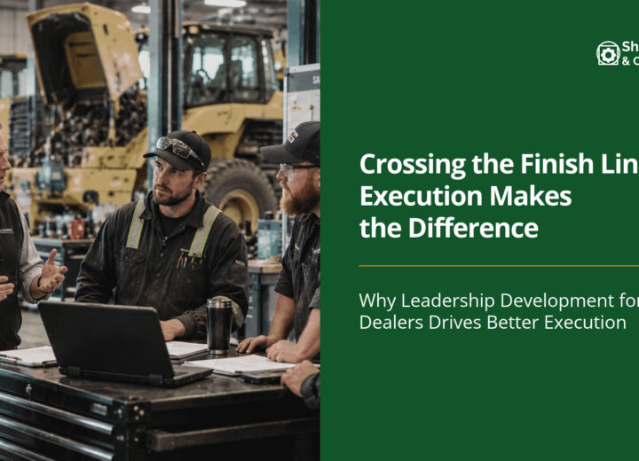 Leadership development for dealers in action, with a heavy equipment dealership team discussing operational performance, teamwork, and continuous improvement in a service workshop.